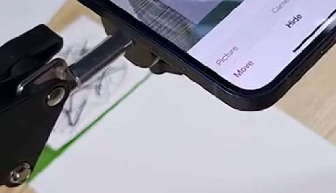 # Da Vinci Eye Drawing Tutorial In this screenshot, a person is using a smartphone to view a reference image of an eye while drawing it on paper using a pencil, demonstrating a common technique for learning to draw realistic eyes by following along with the tutorial.