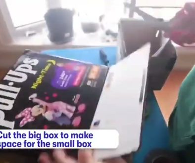 # Screenshot Description The image shows a Philips product box being held up with on-screen text instructing to "Cut the big box to make space for the small box," indicating this is part of a tutorial or instructional video about packaging or box preparation.