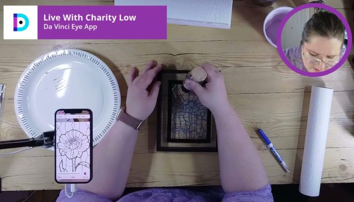 # Description In this Da Vinci Eye App drawing tutorial, the person is tracing or transferring a flower design from a smartphone screen onto paper using a light projection method, with a white paper plate serving as a diffuser for the light source.